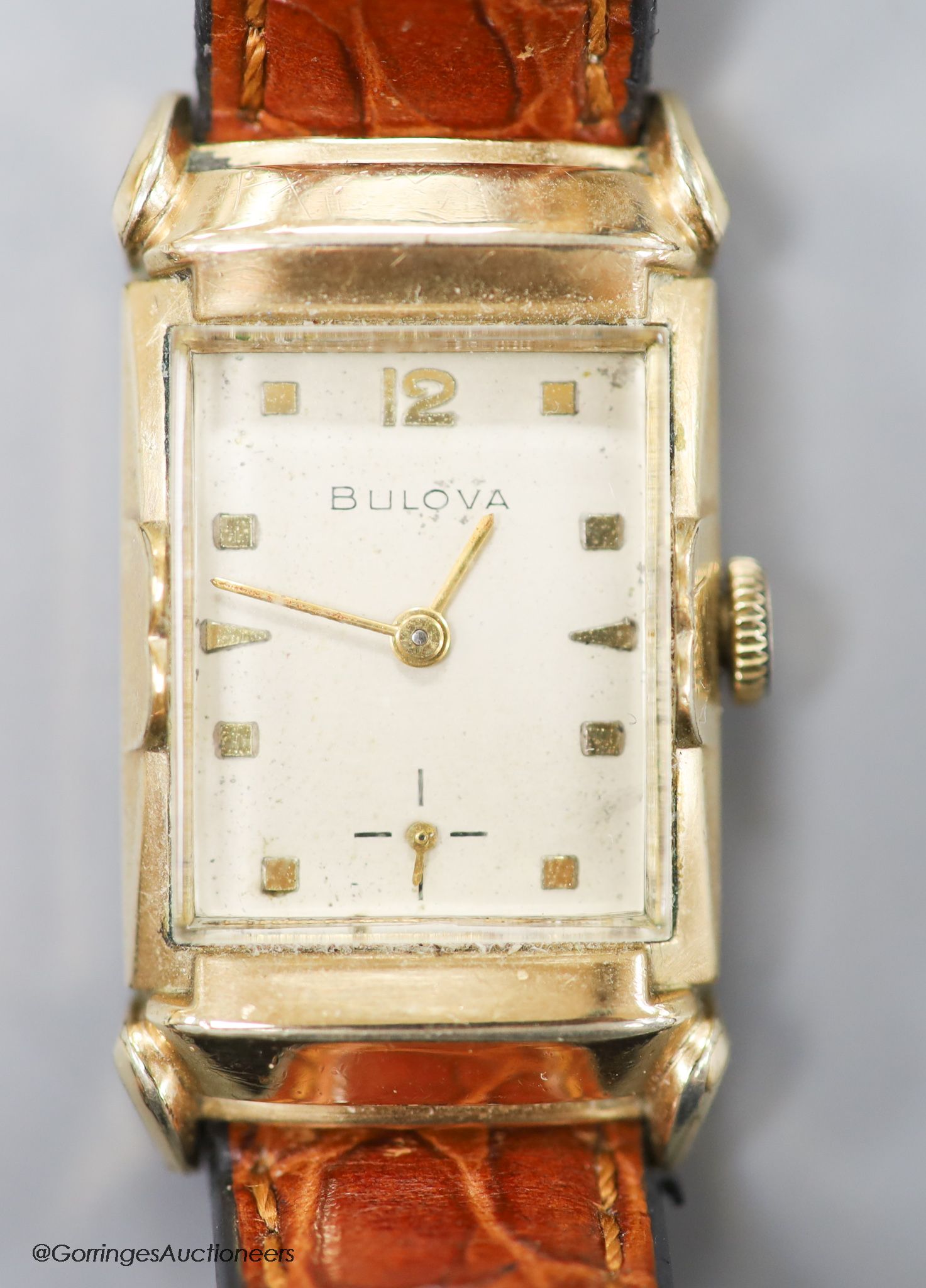 A gentleman's 1930's 10k rolled gold Bulova manual wind rectangular dial wrist watch, with subsidiary seconds, on later leather strap.
